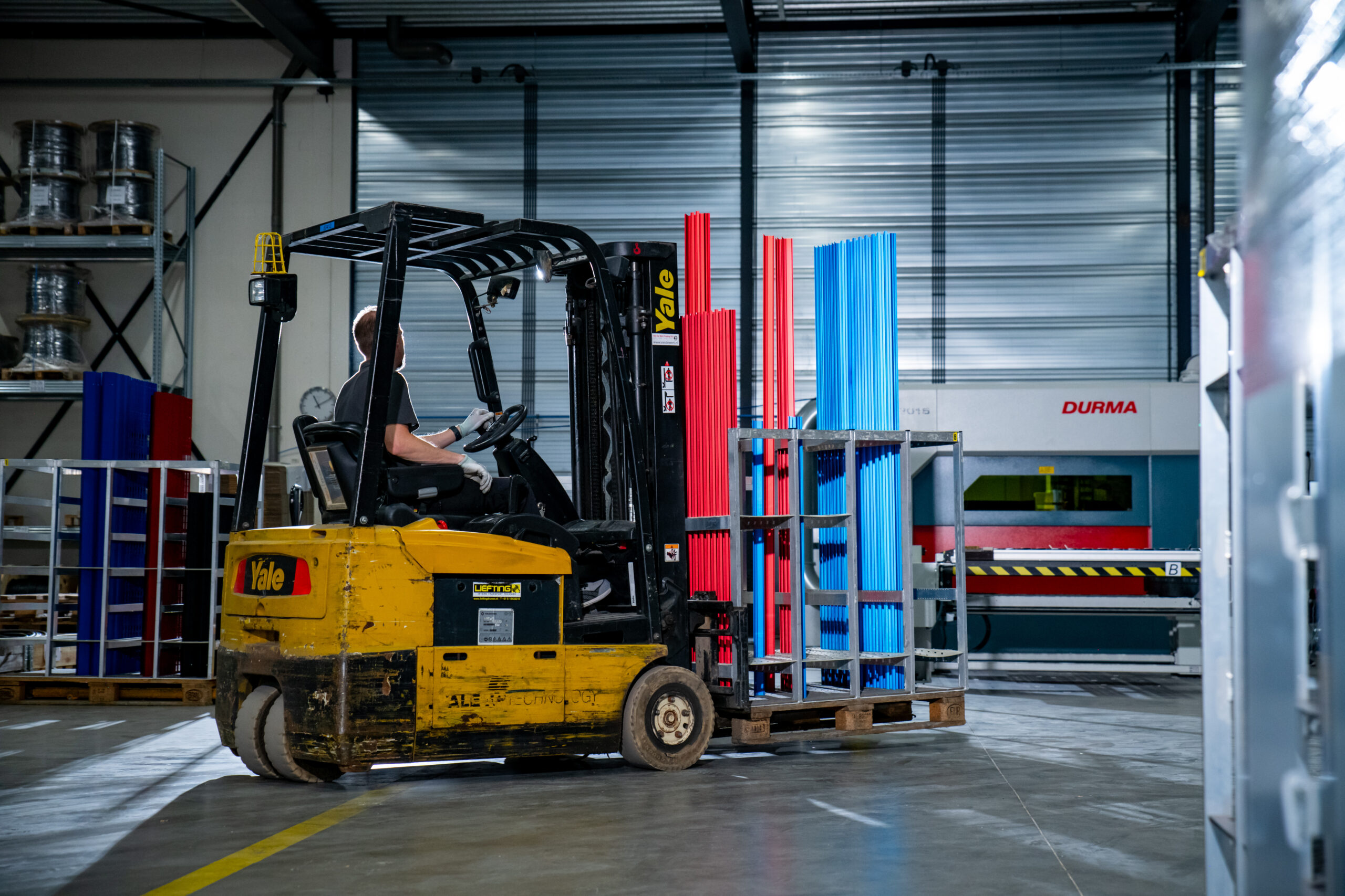Forklift transporting materials on a production floor